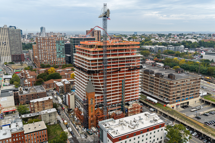 ‘The Lucy’ tops out as developers eye 2028 delivery for distinctive Jersey City apartment tower